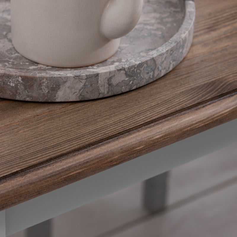 Ceramic mug on a marble coaster on a wooden surface
