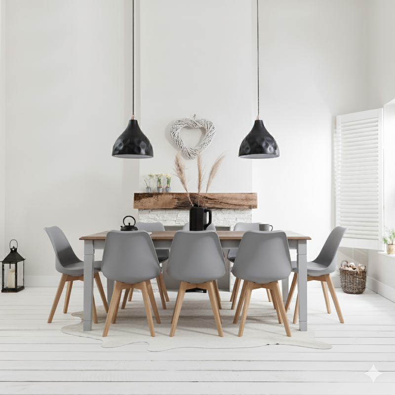 Dining room with a wooden table and gray chairs, black pendant lights, and decorative elements.